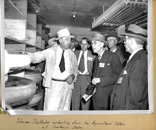 Salesman Conrad Stauffacher conducting a tour for Agricultural Editors of southern states.